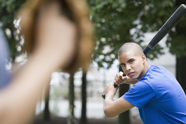 Teenage baseball batter facing pitcher.