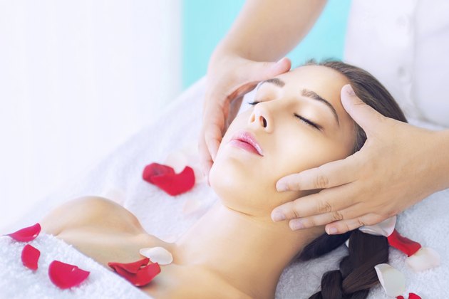 Young woman receiving head massage