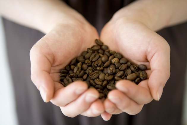 A Woman's Hands Holding Fresh Coffee Beans