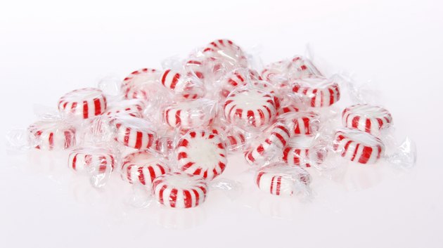 Peppermint candy pile on white background. Red striped