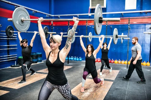 CrossFit gym with guys and gals weightlifting.