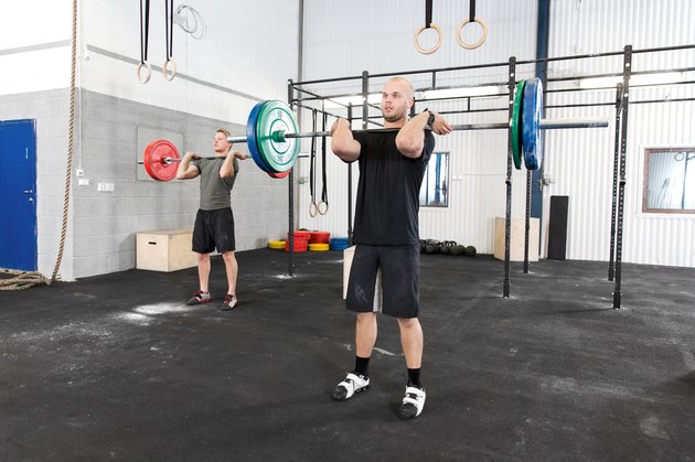 Clean and jerk workout at fitness gym center