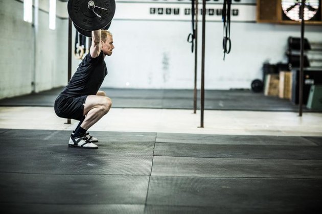 gym - man doing overhead squats