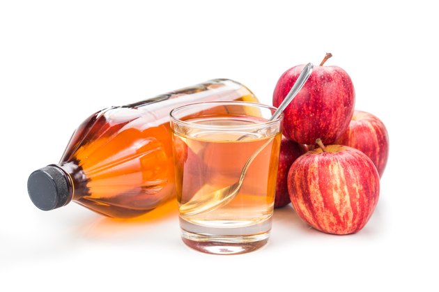 Apple cider vinegar with fresh apple as prop, healthy drink