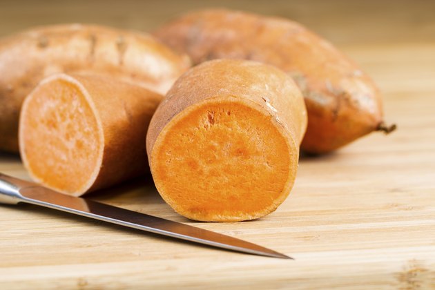 Sliced Yam on natural bamboo cutting board with Knife
