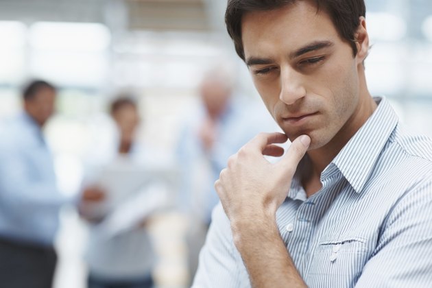 Young business man thinking with colleagues at the back