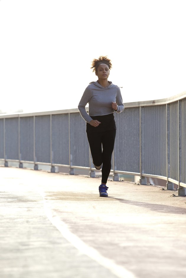 Young female jogger running outdoors