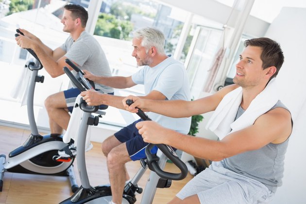 Men exercising on fitness bikes