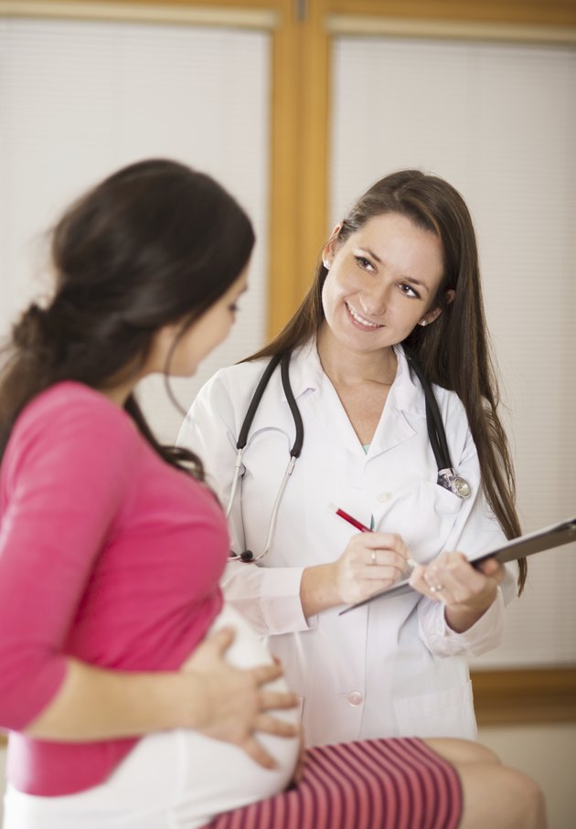 Pregnant woman with doctor