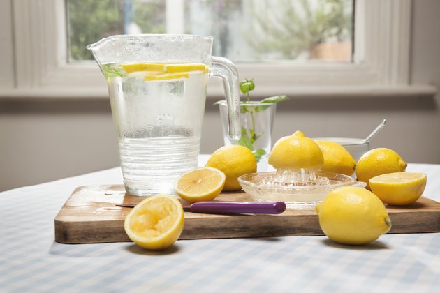 Lemons, juicer and pitcher of water