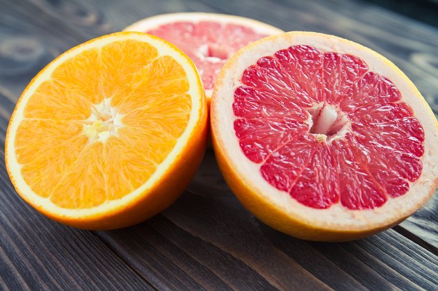 Ripe fresh orange and grapefruit cut in half