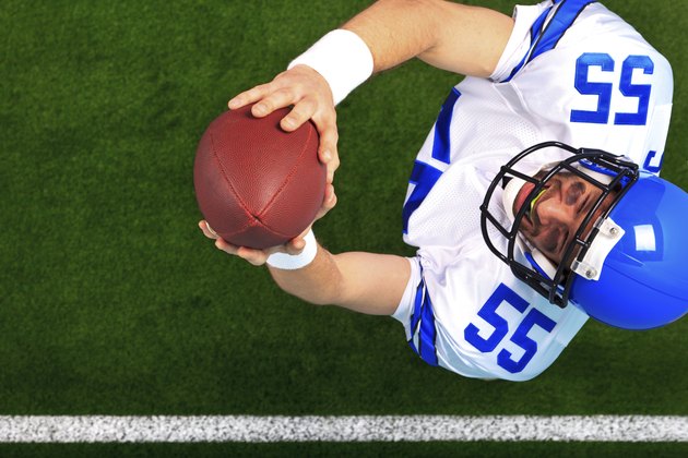 Overhead American football player catching the ball
