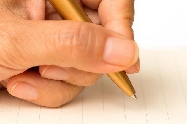 Women writing on paper with a pen on a white background.