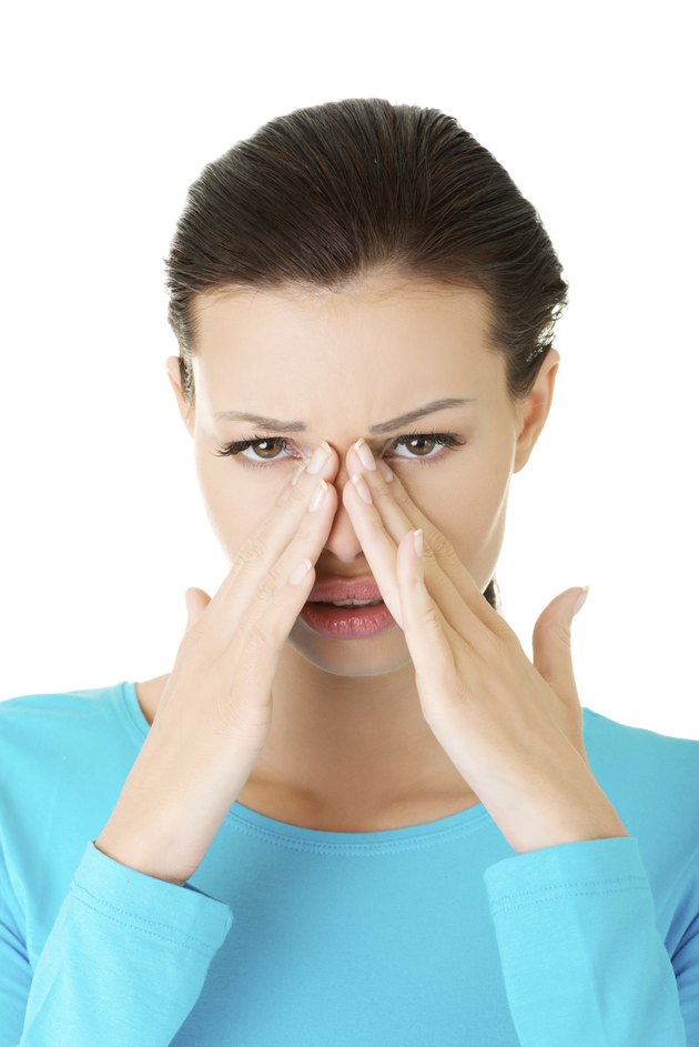 Attractive woman touching her nose.