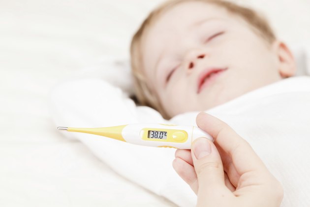 Fever, measuring temperature for little boy
