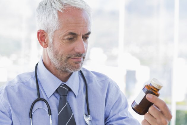 Doctor looking at medicine jar