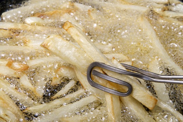 Frying french fries close up