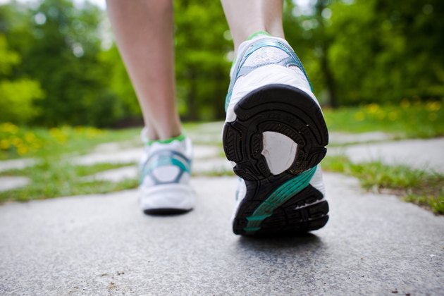 Woman walking cross country and trail in spring forest