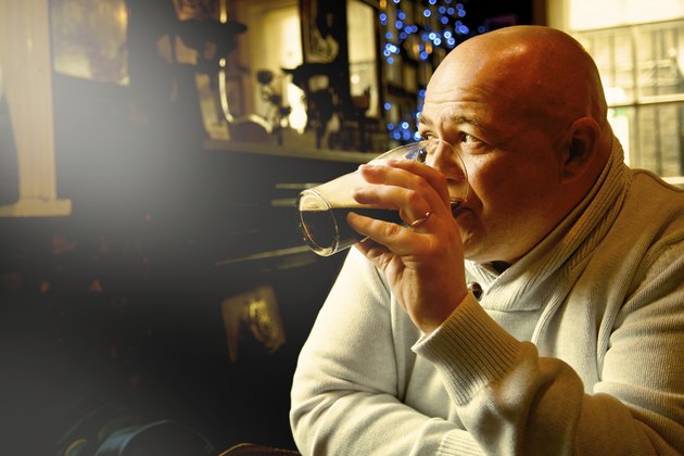 bald man drink pint of stout