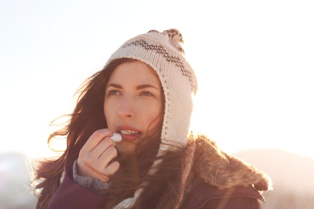 Women outdoor taking care of lips