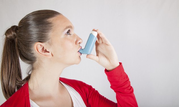 Cute girl with asthma inhaler