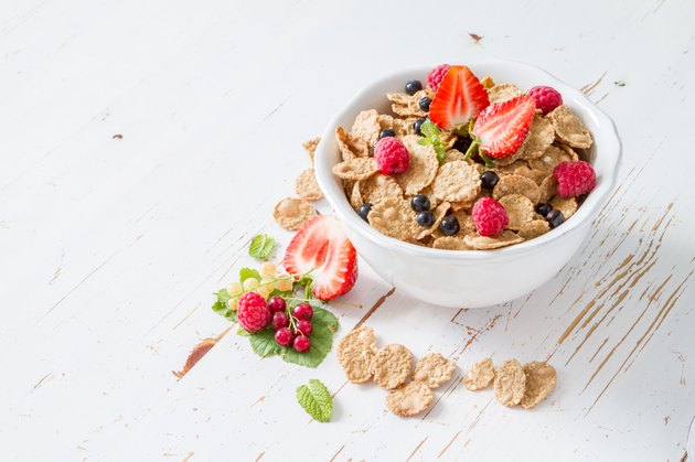 Cereal, strawberry, milk, white wood background