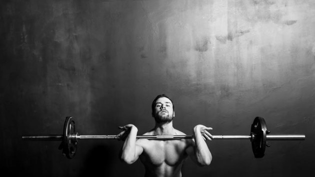 Bodybuilding, Young Athletic Strong Man Weightlifting , Black and White in studio