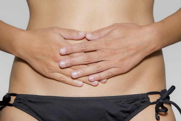 woman has her hands on stomach