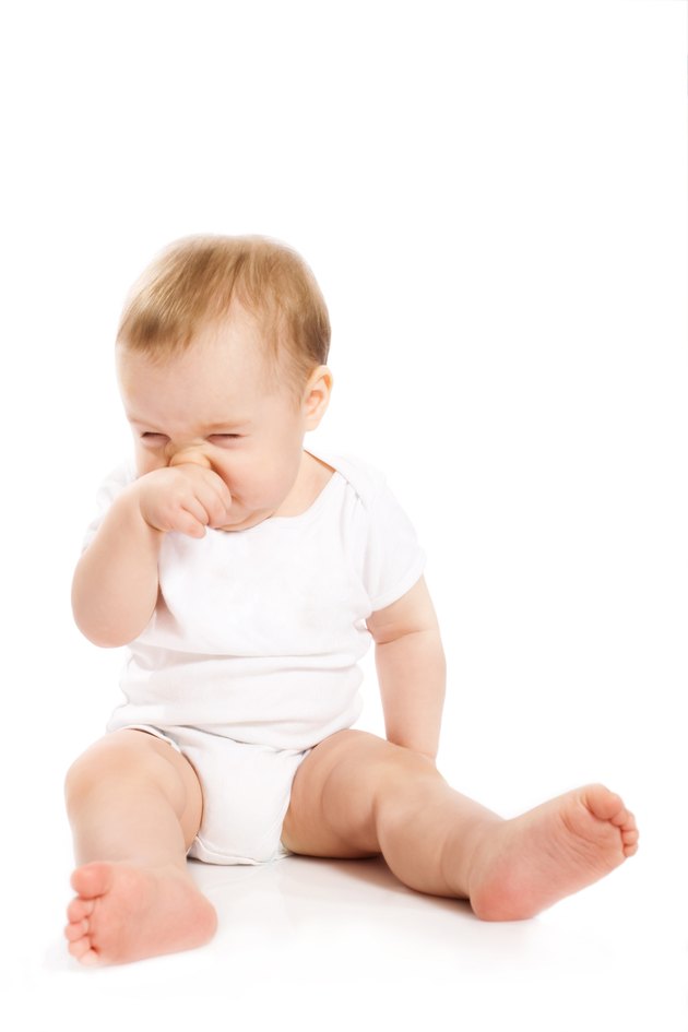 Babys scratching his nose