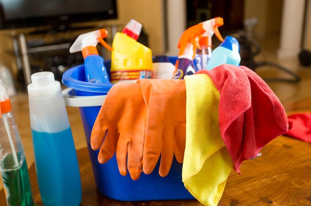 Closeup of bucket full of cleaning products at living room
