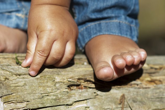 Child hand and foot outdoors