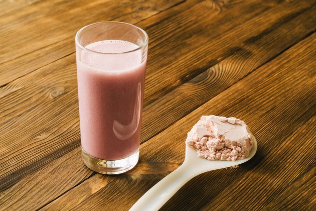 Sports protein on the spoon and in a glass Cup