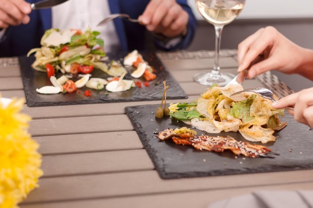 Close-up of people eating in restaurant