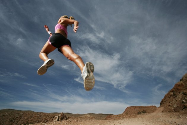 Caucasian woman leaping outdoors