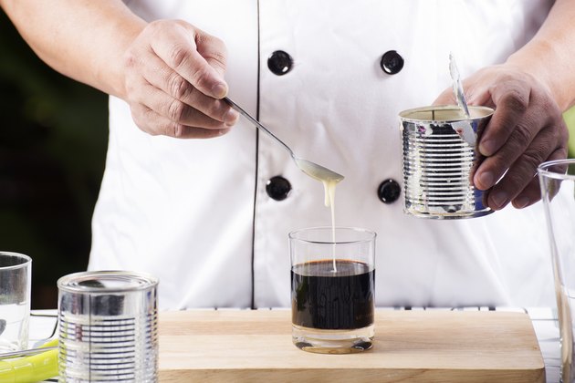 Putting condensed milk in to Hot coffee