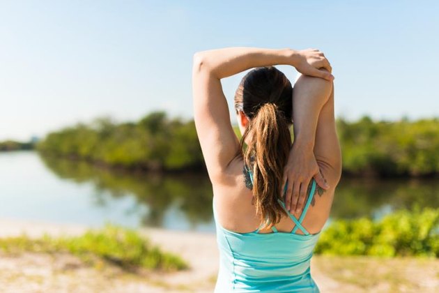 Woman Stretching by Lagoon