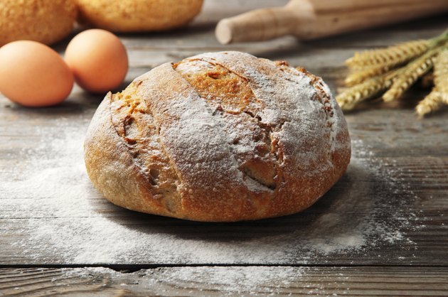 freshly baked loaf of homemade bread on a wooden table