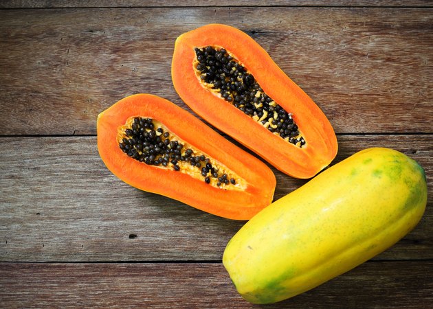 Sliced fresh papaya on wooden background