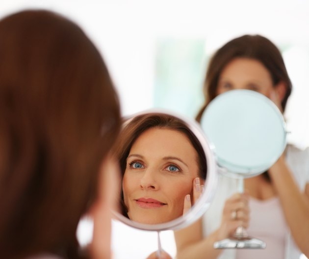 Pretty woman looking into mirror