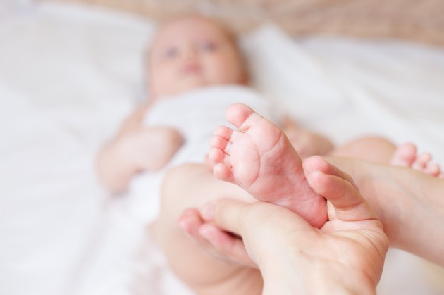 Mother makes healthy massage for baby