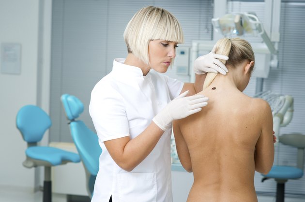 doctor examining woman skin