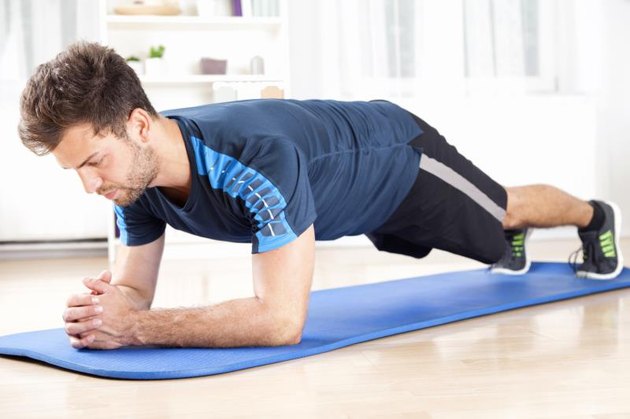 Full Length Shot of a Fit Young Man Performing Planking Exercise on a Mat While Facing the Floor.