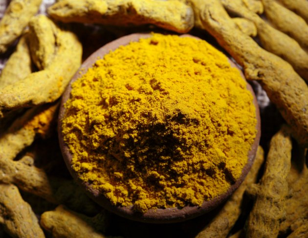 Top angle view of turmeric powder and dry turmeric