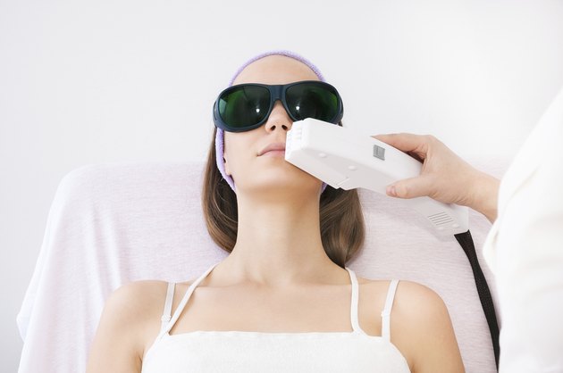 Young woman receiving laser epilation treatment on upper lip