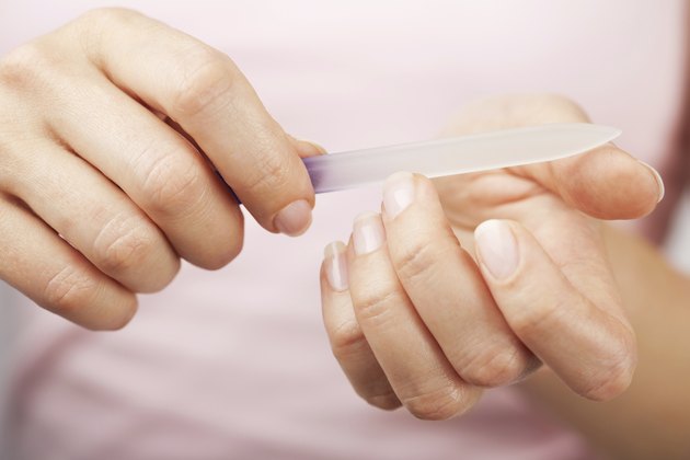 beautiful woman hands with nail file