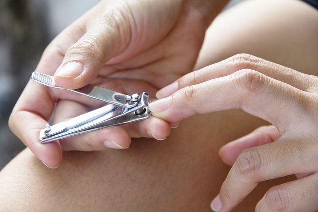 hand manicure with nail clipper