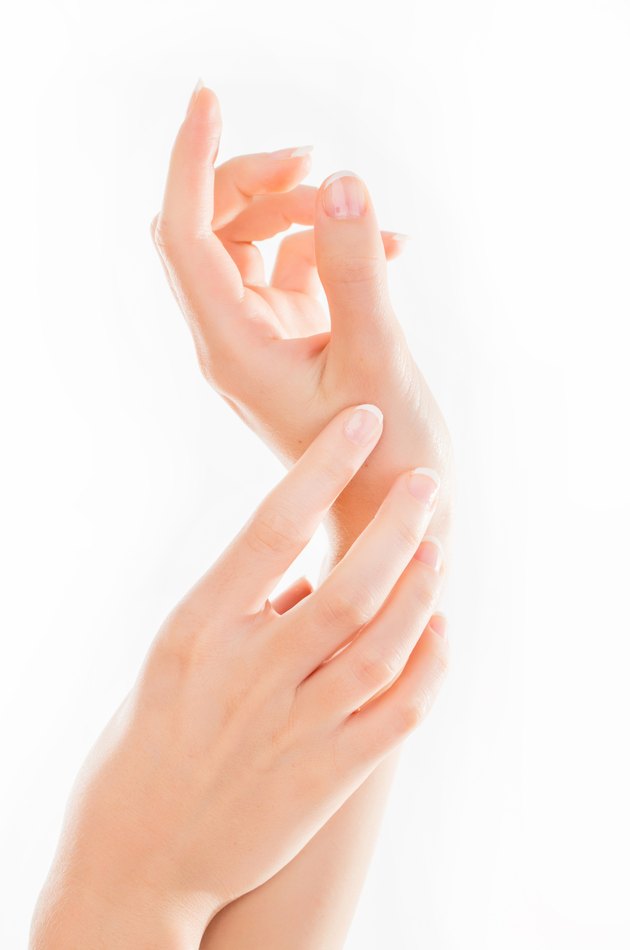 Beautiful young woman hands with cream, isolated on white
