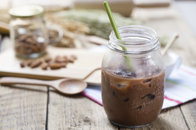 Cold Chocolate Milk drink (close-up shot) on wooden background