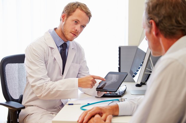 Male Patient Having Consultation With Doctor In Office
