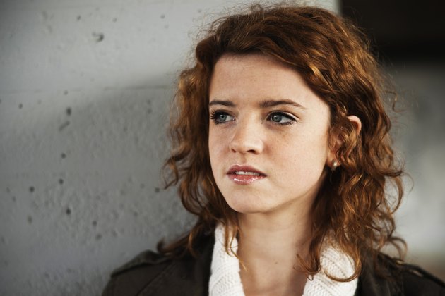 Serious teenager girl with curly hair